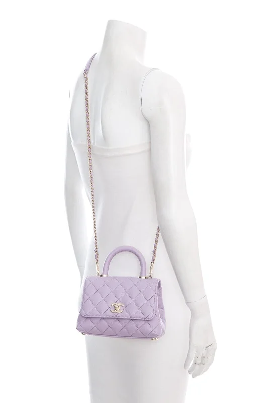 Chanel bags with the perfect balance of luxury and functionalityChanel 2023/24  Purple Caviar Quilted Coco Handle Mini Flap